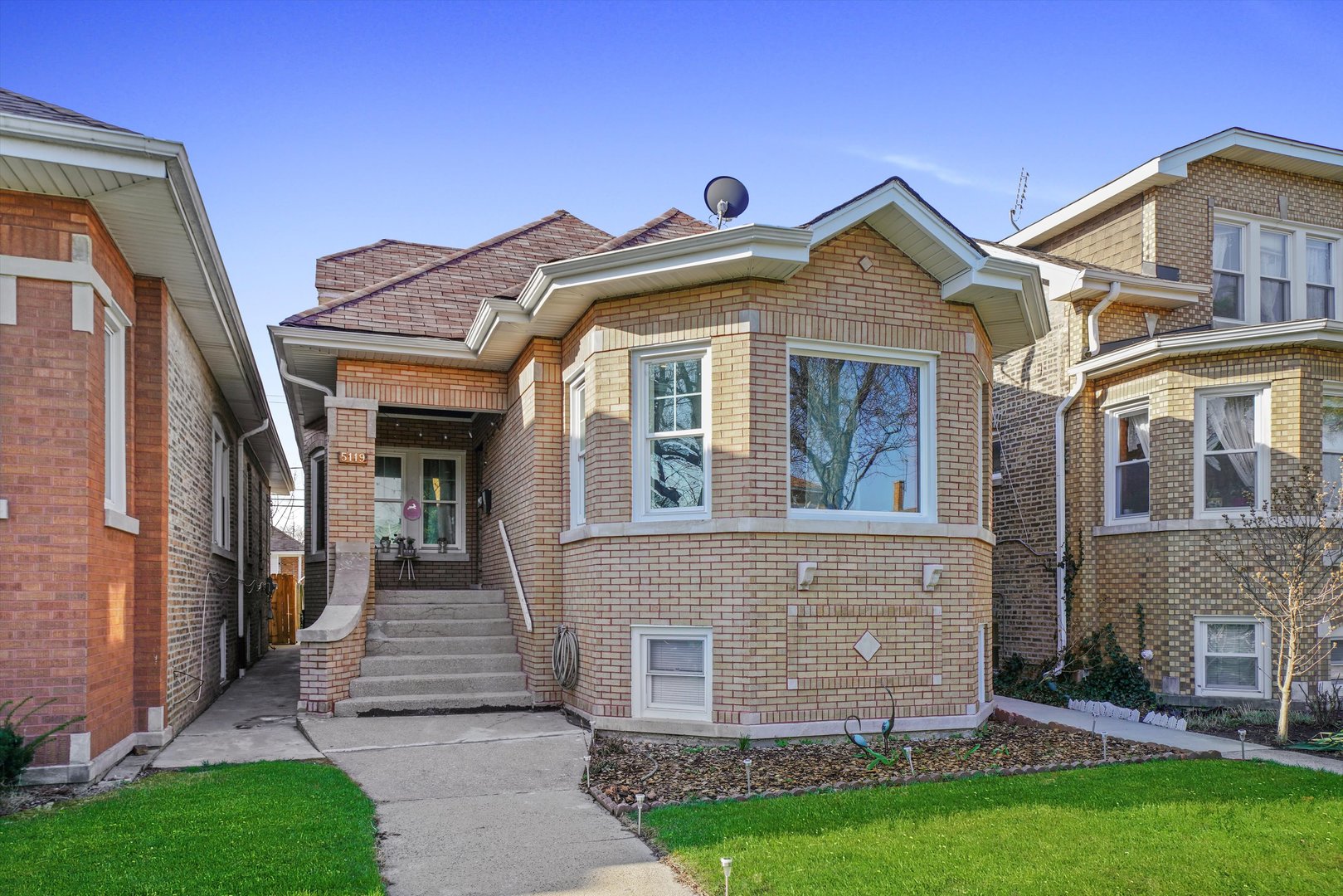 Undisclosed Address Chicago, IL 60641 - Photo 2 of 32 a view of a brick house with a yard plants and large tree