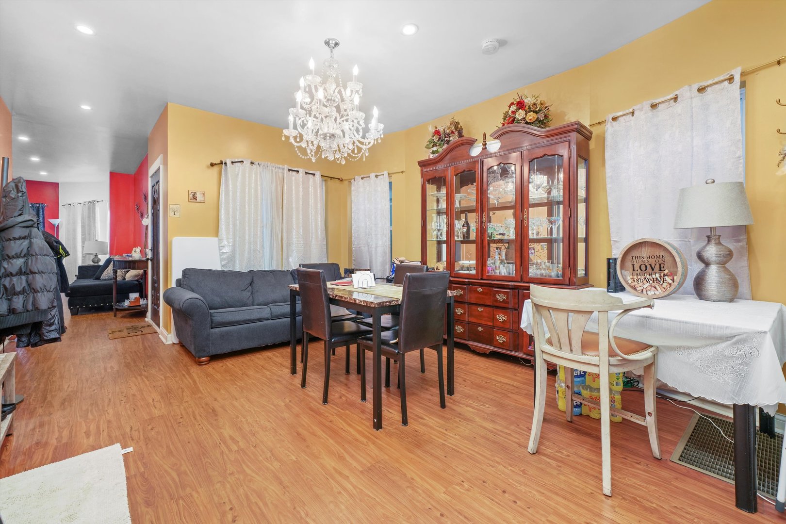 Undisclosed Address Chicago, IL 60641 - Photo 6 of 32 a view of a dining room with furniture a chandelier and wooden floor