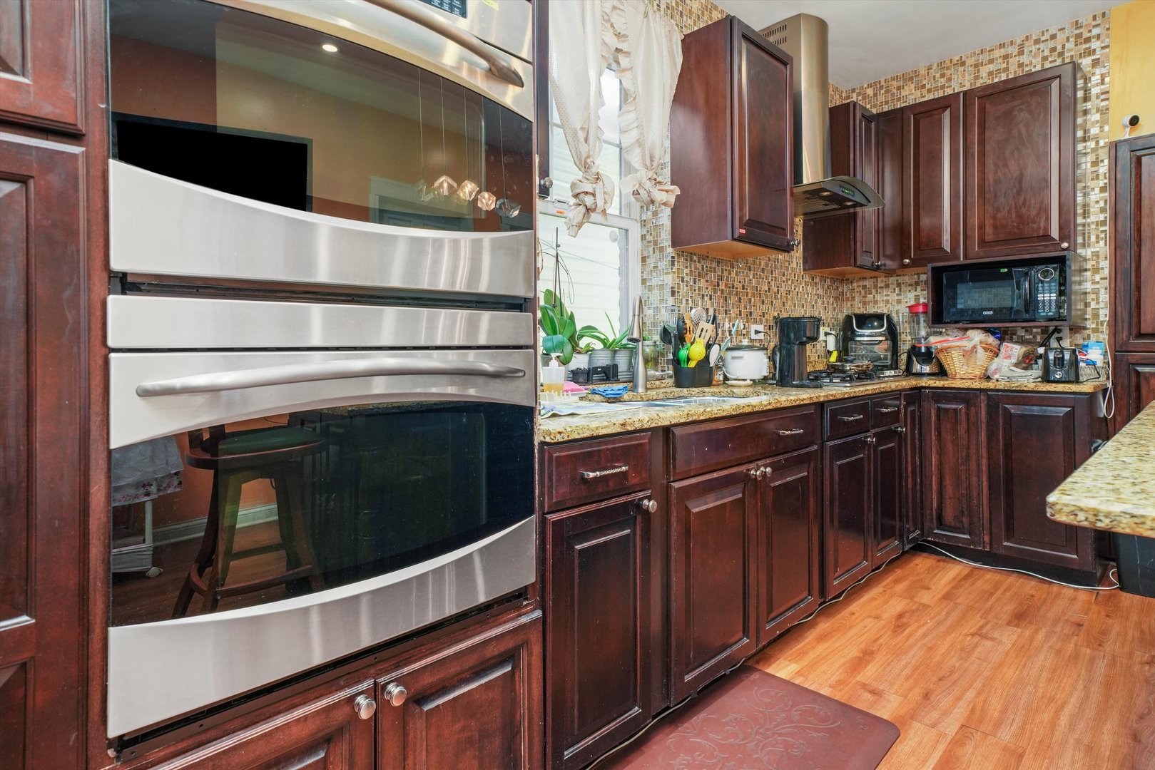 Undisclosed Address Chicago, IL 60641 - Photo 9 of 32 a kitchen with stainless steel appliances granite countertop a stove and a sink