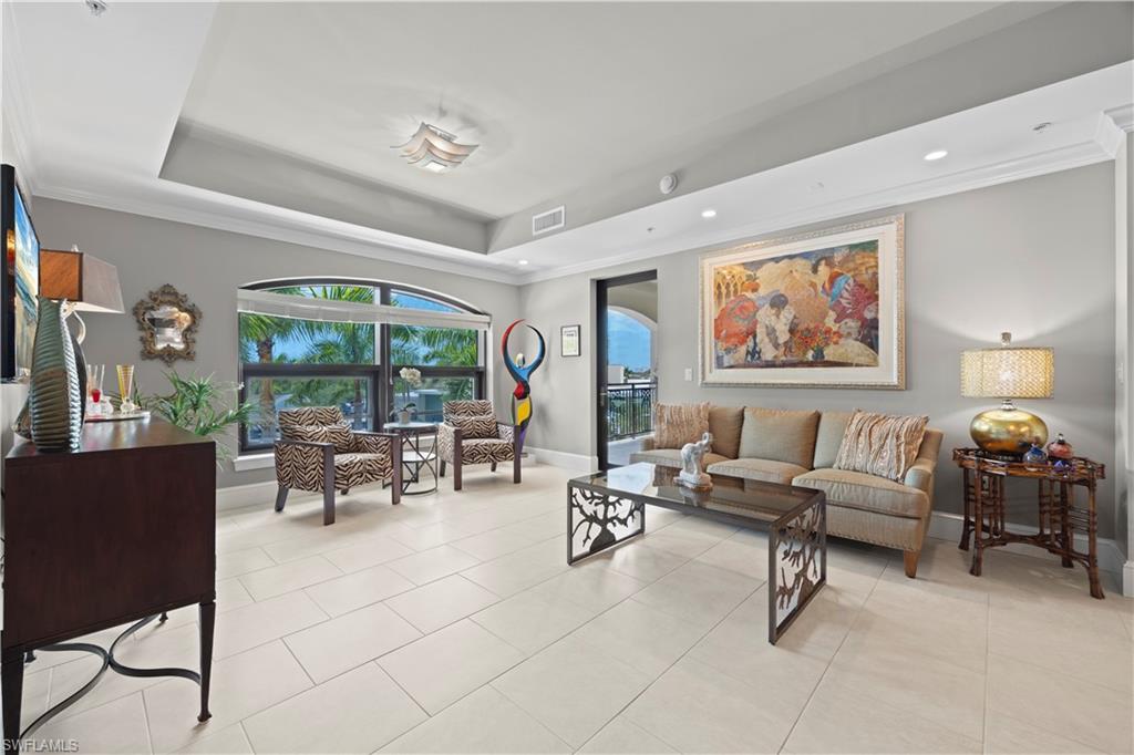 9115 Strada Place, Unit 5314 Naples, FL 34108 - Photo 9 of 44 a living room with furniture and floor to ceiling window