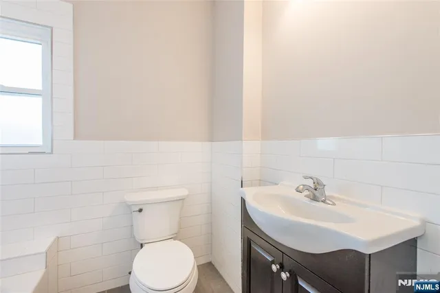 a bathroom with a sink toilet and a mirror