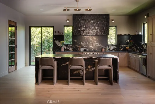 a kitchen with a sink stove and cabinets