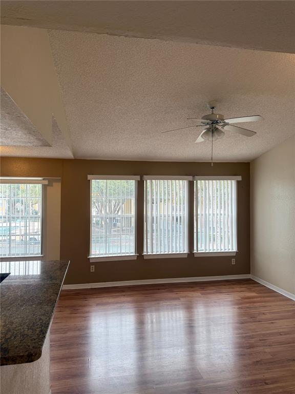 1049 South Hiawassee Road, Unit 3428 Orlando, FL 32835 - Photo 5 of 21 an empty room with wooden floor and windows