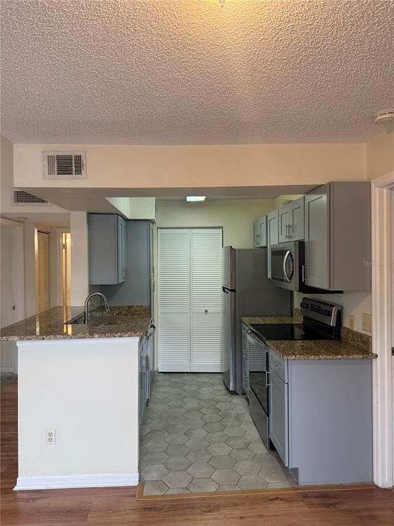 1049 South Hiawassee Road, Unit 3428 Orlando, FL 32835 - Photo 6 of 21 a kitchen with stainless steel appliances granite countertop a sink and a stove