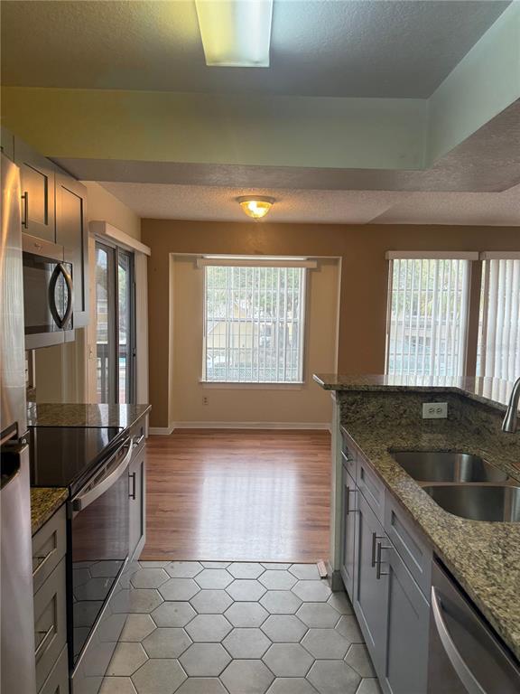 1049 South Hiawassee Road, Unit 3428 Orlando, FL 32835 - Photo 9 of 21 a kitchen with granite countertop a sink and a stove