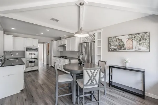 a dining room with furniture and window