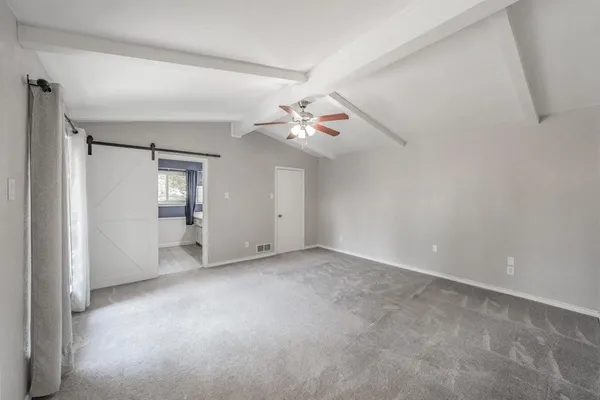a view of an empty room with a bathroom