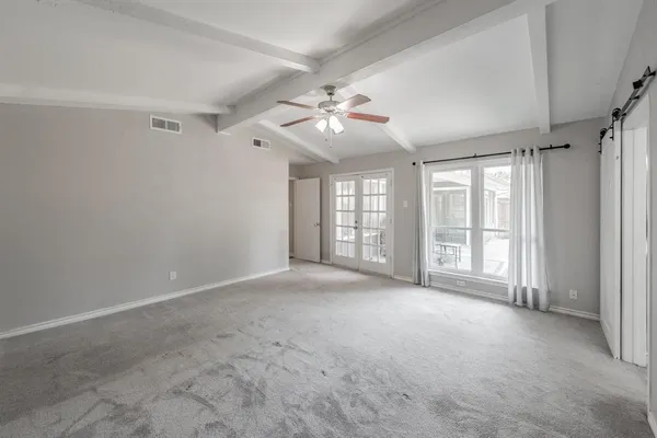 a view of an empty room with a window