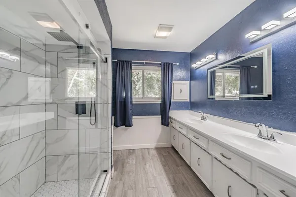 a spacious bathroom with a bathtub and a sink