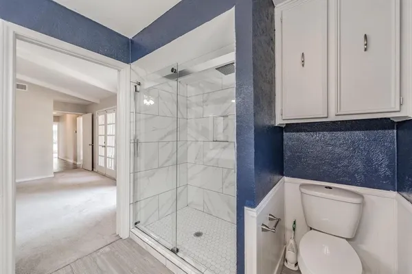 a bathroom with a toilet and shower