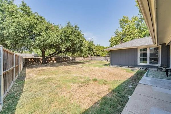 a view of backyard of house with green space