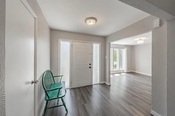 a view of a room with wooden floor and windows