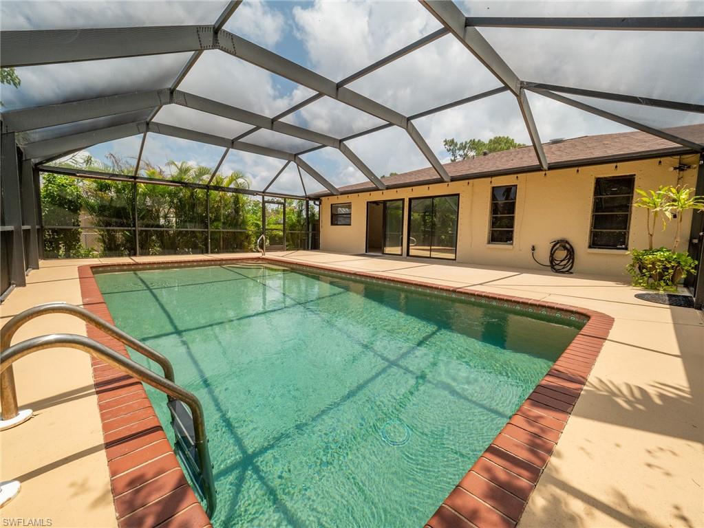 18414 Tulip Road Fort Myers, FL 33967 - Photo 33 of 37 Screened-in swimming pool with a rectangular shape and brick coping