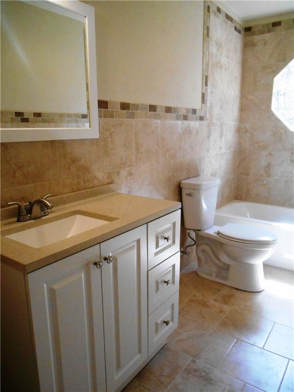 36 Simon Road Cheswick, PA 15024 - Photo 14 of 25 AMAZING main level bathroom!! All custom tile work, new vanity, toilet, mirror and fixtures!