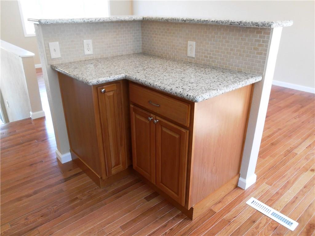 36 Simon Road Cheswick, PA 15024 - Photo 8 of 25 Custom tile work and beautiful granite counter top accent the center island! Imagine all of the food you can serve your guests on these two levels of counter space!