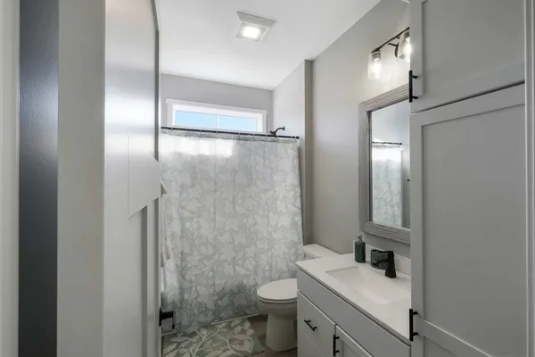 a bathroom with a sink toilet and shower