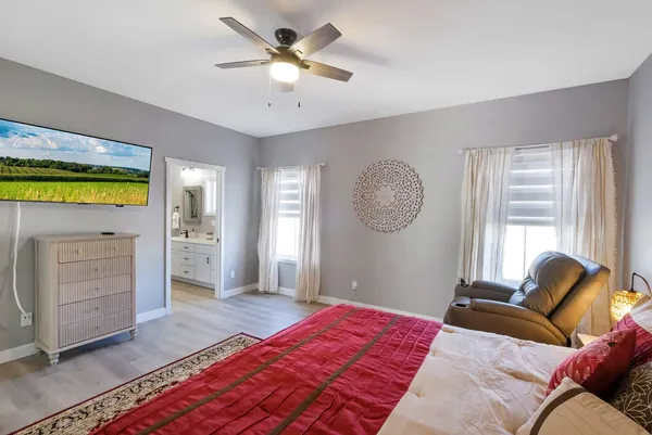 a bedroom with a bed and a chandelier