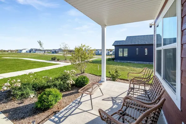 a view of a chairs and table in patio