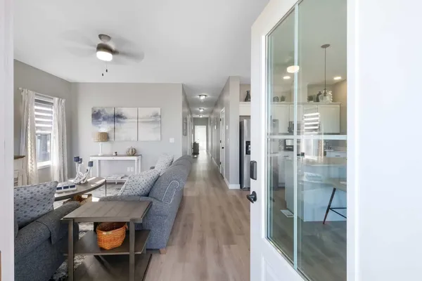a living room with furniture and a chandelier