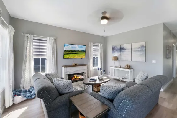 a living room with furniture and a fireplace