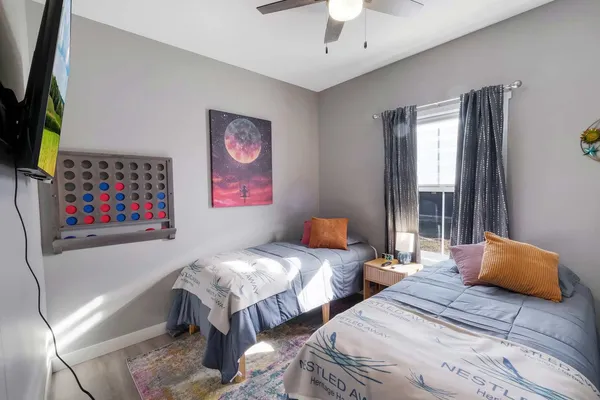 a bedroom with two beds and a chandelier