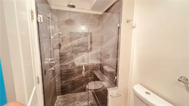 a bathroom with a shower and a toilet