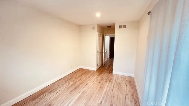 a view of hallway with wooden floor