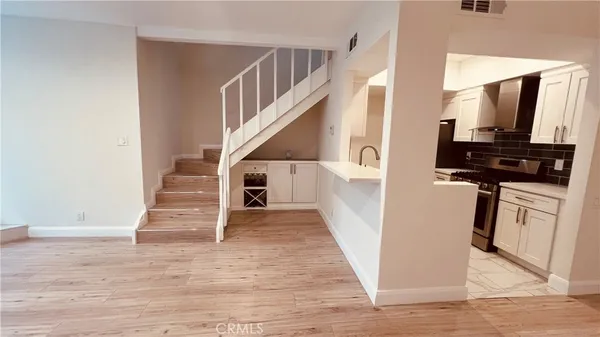 a view of entryway and hall with wooden floor