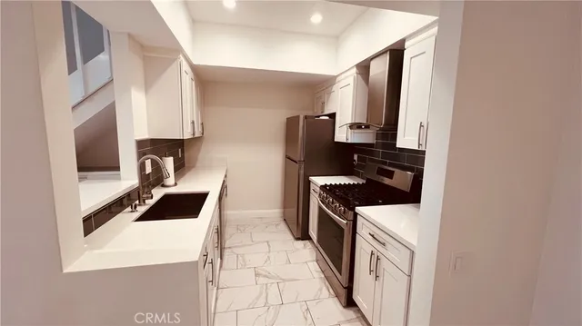 a kitchen with a sink a stove and refrigerator