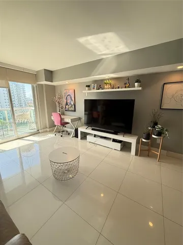 a living room with furniture and a flat screen tv