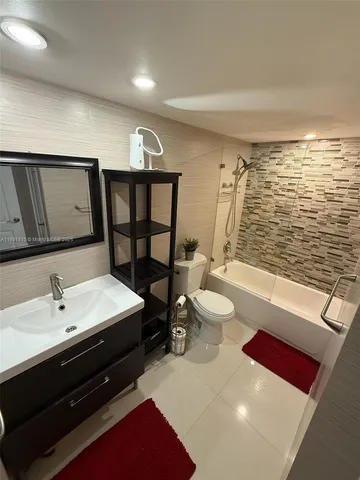 a spacious bathroom with a double vanity sink a toilet and shower