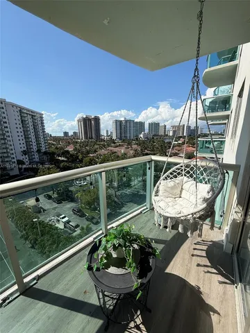 a view of a balcony and dining table with chairs