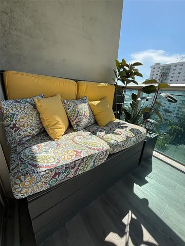 a bed sitting in a bedroom next to a window with potted plants