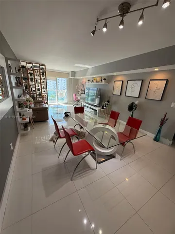 a living room with furniture a air conditioner and a window