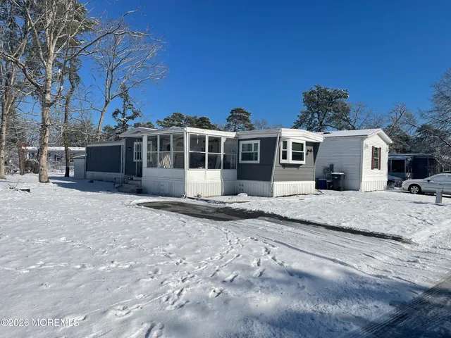 a view of a house with a yard and sitting area