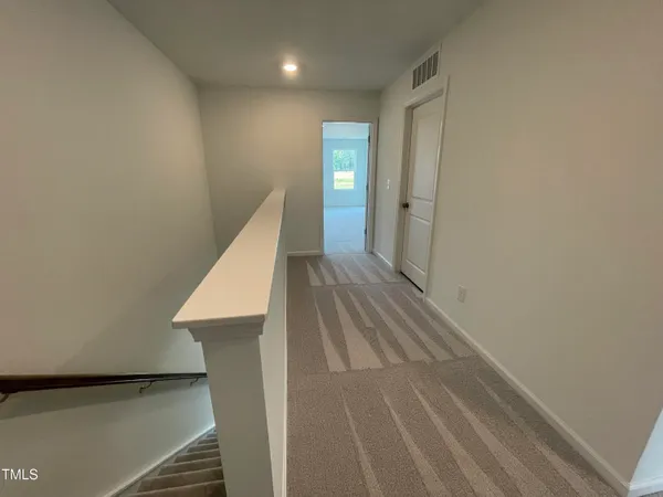 a view of a hallway with staircase