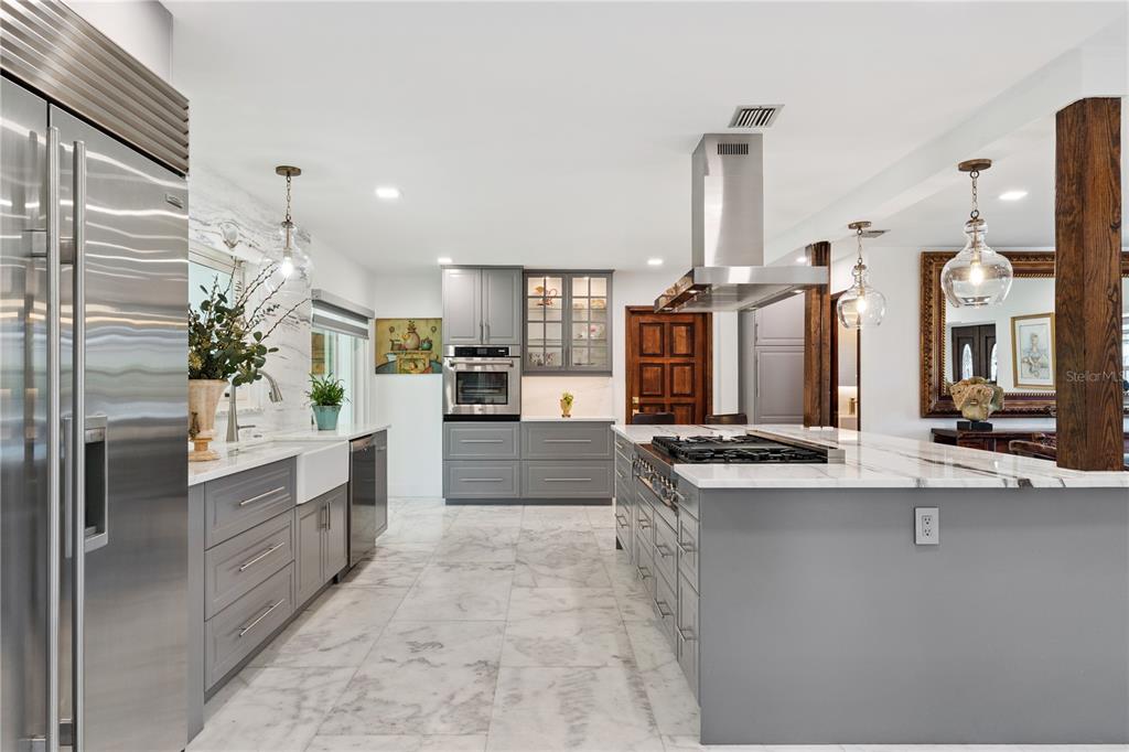 7621 Orange Tree Lane Orlando, FL 32819 - Photo 11 of 47 a kitchen with stainless steel appliances granite countertop a sink and cabinets