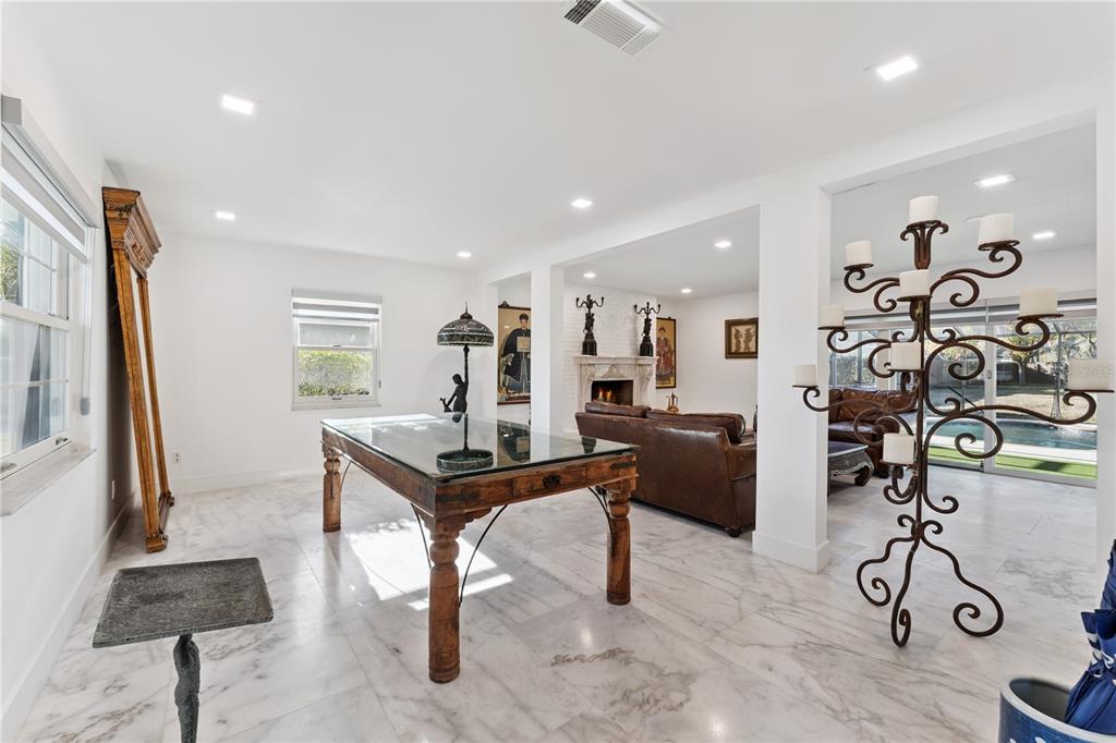 7621 Orange Tree Lane Orlando, FL 32819 - Photo 14 of 47 a living room with furniture a table and wooden floor