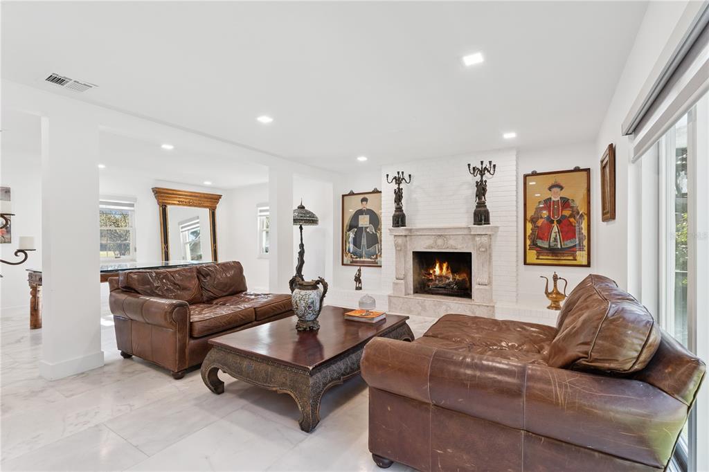 7621 Orange Tree Lane Orlando, FL 32819 - Photo 17 of 47 a living room with furniture and a fireplace