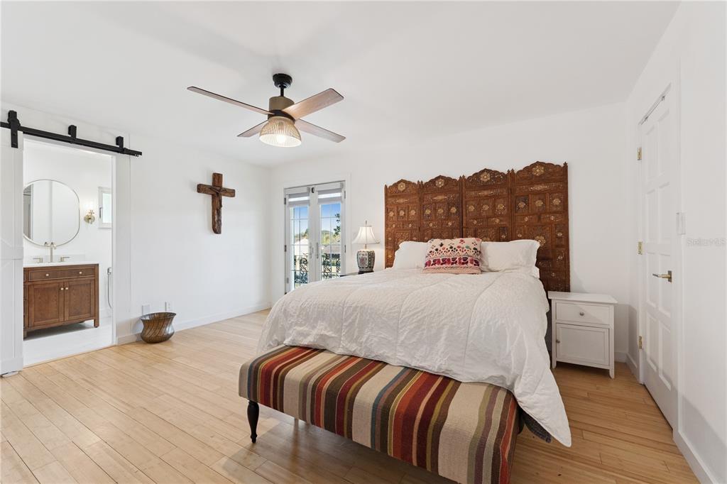 7621 Orange Tree Lane Orlando, FL 32819 - Photo 20 of 47 a bedroom with a bed and a chandelier