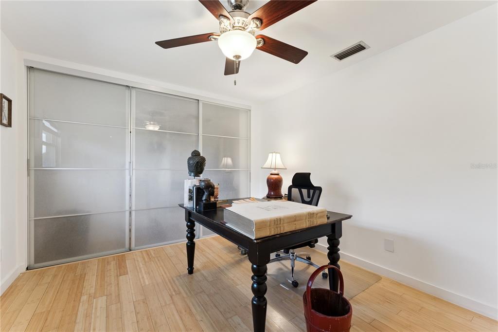 7621 Orange Tree Lane Orlando, FL 32819 - Photo 28 of 47 a view of a workspace with furniture and a chandelier fan