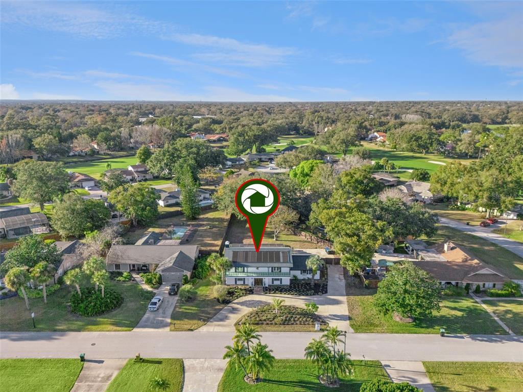7621 Orange Tree Lane Orlando, FL 32819 - Photo 43 of 47 an aerial view of a city with lots of residential buildings