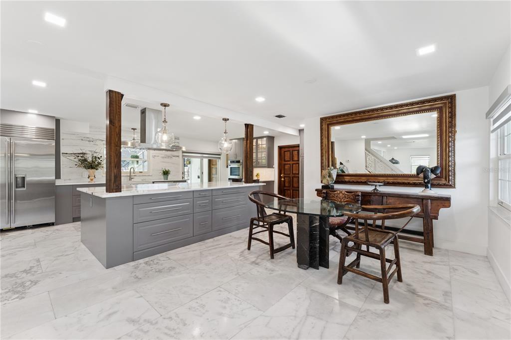 7621 Orange Tree Lane Orlando, FL 32819 - Photo 7 of 47 a living room with stainless steel appliances kitchen island granite countertop furniture and a large window