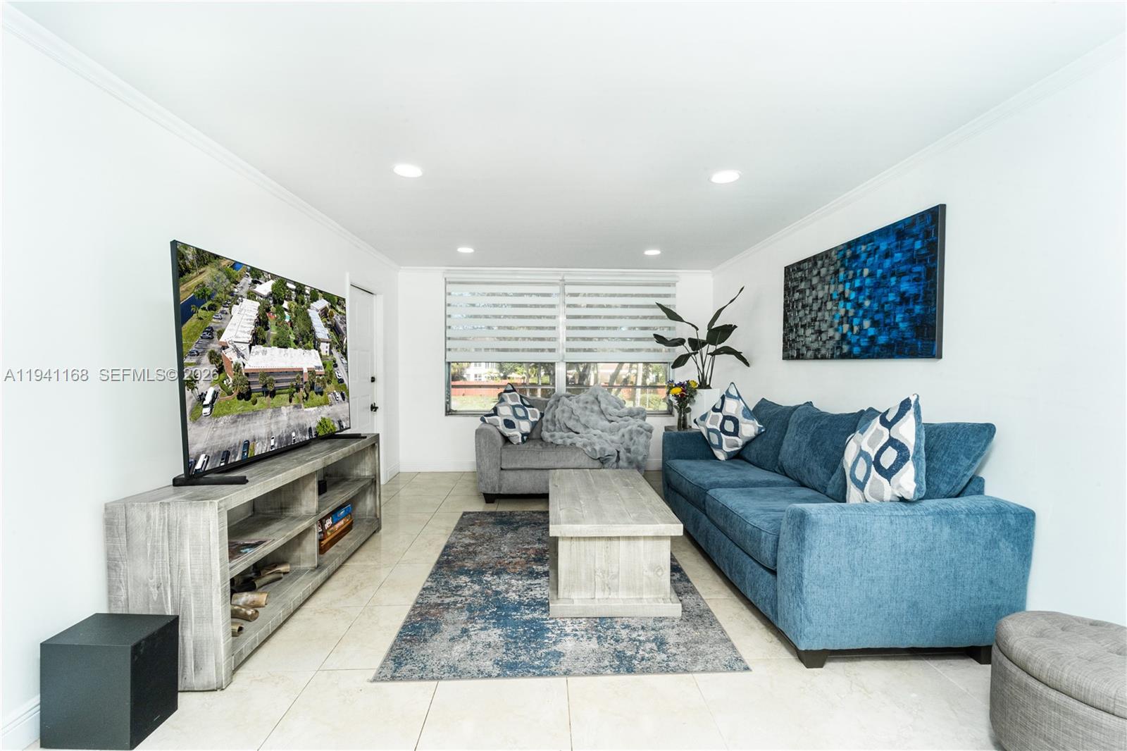 a living room with furniture and a flat screen tv