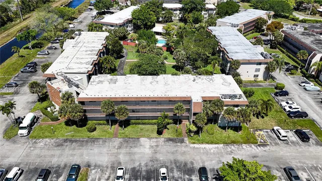 an aerial view of a house with a yard and outdoor seating
