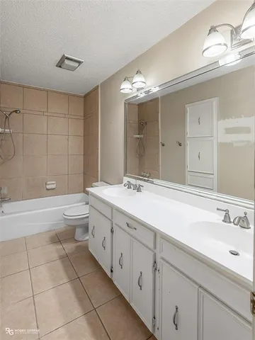 a spacious bathroom with a double vanity sink mirror and toilet