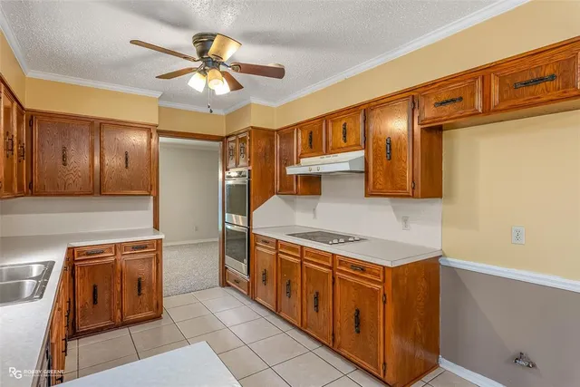 a kitchen with stainless steel appliances granite countertop a sink and cabinets