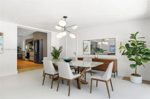a view of a dining room with furniture and a potted plant