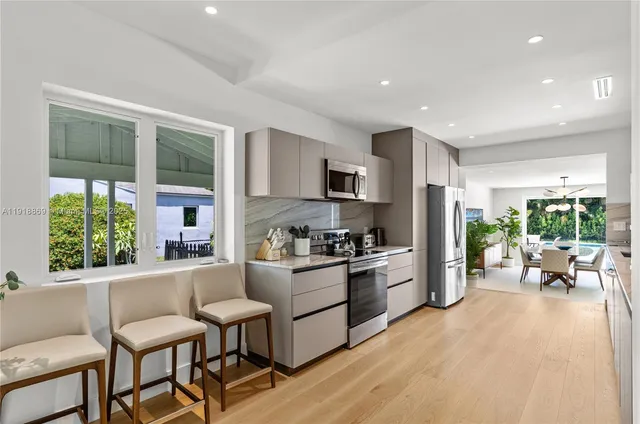 a kitchen with stainless steel appliances granite countertop a refrigerator and a sink