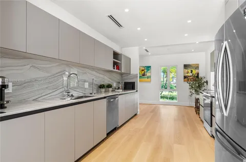 a kitchen with stainless steel appliances a stove a sink a microwave and cabinets